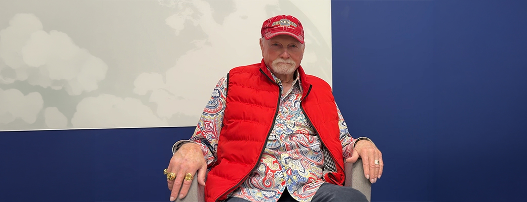 Image of Mike Love sitting in chair and talking about his hearing loss and experience with Starkey hearing aids